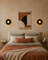Warm bedroom wall light glowing softly beside a bed