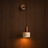 Kovak Scandinavian travertine and wood wall light on a wood wall — NOGAN Lights