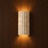 Crunda Nordic-style travertine wall light on a wood-panelled wall — NOGAN Lights