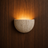 Vidde half-moon travertine wall light on a wood-panelled wall — NOGAN Lights