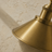 Adjustable brass wall light shown with its arm directing light