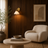 White glass wall light casting a soft diffused glow in a calm living room