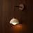 Eira modern travertine and wood wall light on a wood wall, NOGAN Lights