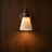 Almo Scandinavian travertine and wood wall light on a wood wall, NOGAN Lights