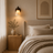 Travertine and wood wall light casting a warm glow in a modern Nordic room