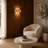 Travertine LED wall light casting a warm ambient glow in a modern living room