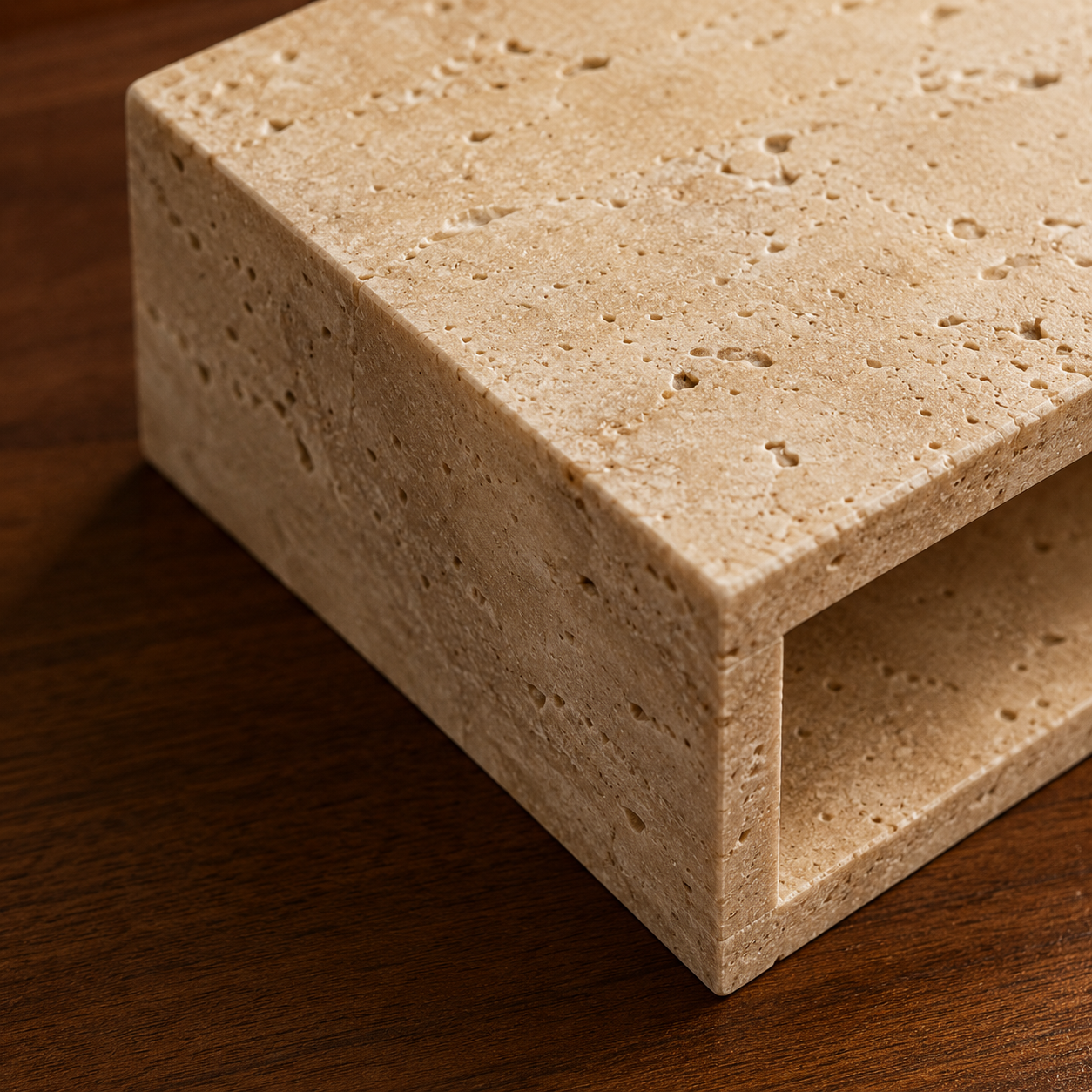 Travertine LED wall light shown lit against a dark wood wall
