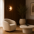 Minimalist travertine and wood wall light casting a warm glow in a modern living room
