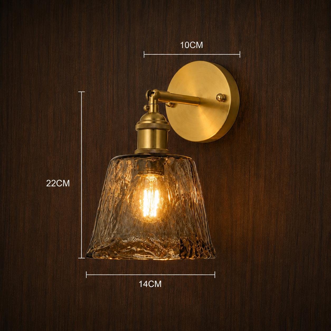 Vintage amber glass wall light shown lit against a wall